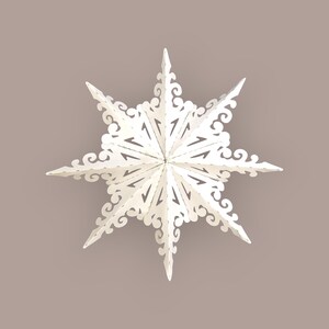 Peut inclure: Une décoration en forme d'étoile blanche à huit branches, avec des motifs découpés complexes. L'étoile a des pointes acérées et des motifs décoratifs en spirale sur les bords. Une décoration festive sur le thème des fêtes.