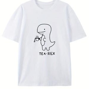 May include: White t-shirt featuring a black line drawing of a dinosaur holding a teacup. The text "TEA-REX" is printed below the dinosaur. The shirt has short sleeves and a crew neck.