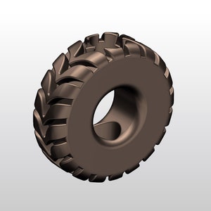 May include: A brown rubber tire with a deep tread pattern. The tire is designed for off-road use and has a large diameter.