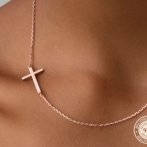 May include: A rose gold necklace featuring a delicate cross pendant. The necklace is made from real sterling silver and has a 925 hallmark.