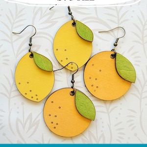 May include: Three pairs of wooden earrings in the shape of lemons and oranges. The earrings are yellow and orange with green leaves and brown hooks. The text "Glowforge Ready SVG FILE" is at the top of the image. The text "not a physical product" is at the bottom of the image.