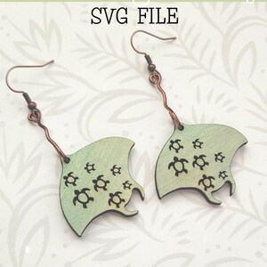 May include: A pair of green and iridescent earrings shaped like stingrays with small turtle designs. The earrings are made of wood and have copper-colored hooks. The text "Glowforge Ready SVG FILE" is at the top of the image. The text "not a physical product" is at the bottom of the image.