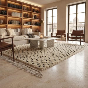 May include: A cozy living room featuring a cream-colored sofa, a patterned rug with black accents, and a marble coffee table. The room is illuminated by natural light from large windows and a warm glow from the built-in bookshelves.