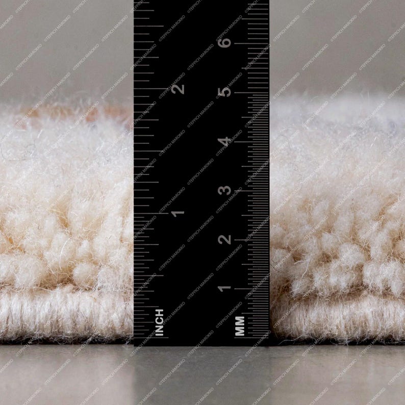 a close up of a measuring ruler on a rug
