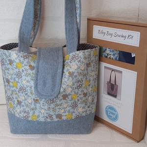 May include: A blue and white floral fabric tote bag sewing kit. The kit includes fabric, instructions, and a pattern for a small tote bag. The box is labelled "Riley Bag Sewing Kit" and "Sewing Days".
