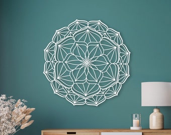 May include: White mandala wall decor with intricate details, featuring a circular design with a floral pattern. The mandala is against a teal wall.