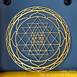 May include: Gold-colored Sri Yantra mandala wall art with a geometric design. The mandala is 36.22 inches (92 cm) in diameter.