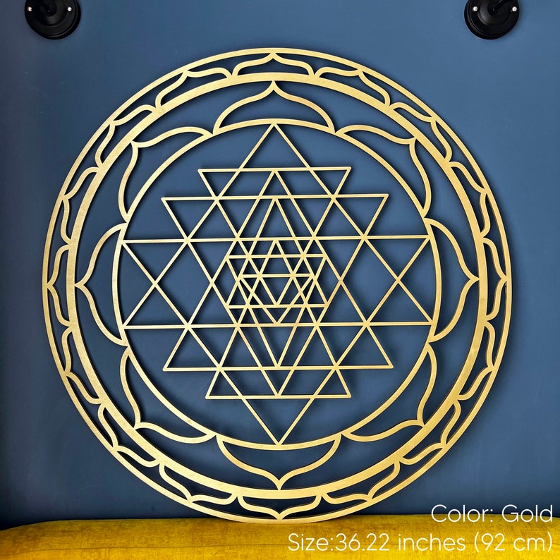 May include: Gold-colored Sri Yantra mandala wall art with a geometric design. The mandala is 36.22 inches (92 cm) in diameter.