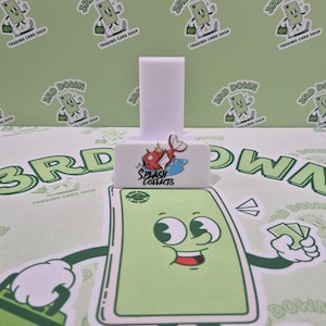 May include: White plastic card holder with a red fish logo that says "Splash Collects".