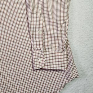 May include: A white and brown checkered long-sleeve shirt with a button cuff.
