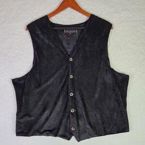 May include: A black velvet vest with a V-neck and button closure. The vest has a label that reads "Jay Jacobs".