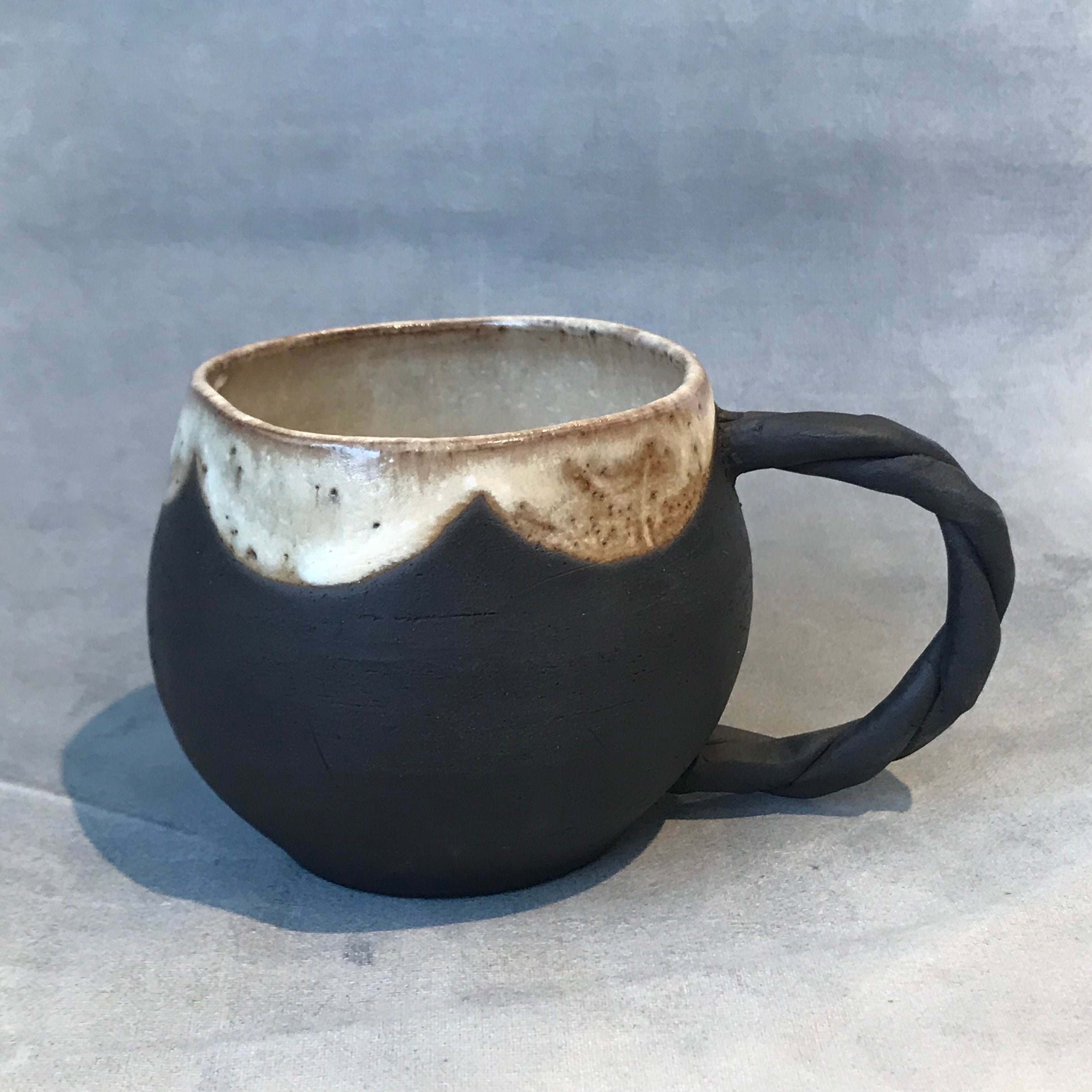 Black clay coffee mug with white scalloped glaze. handmade Etsy