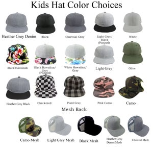 May include: A selection of kids' hats in various colors and patterns, including heather grey denim, black, charcoal grey, light grey, white, black Hawaiian, white Hawaiian, olive, checkered, plaid grey, pink camo, camo, camo mesh, light grey mesh, black mesh, heather grey denim mesh, and charcoal mesh. The hats are arranged in two rows, with the top row showing the solid colors and the bottom row showing the patterned hats. The text "Kids Hat Color Choices" is at the top of the image, and the text "Mesh Back" is in the middle of the image.