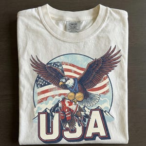 Funny USA Ice Hockey Eagle, USA Champions 2026 Shirt, USA Hockey Shirt 2026, Patriotic Ice Hockey Tee, Funny Sports Unisex T-shirt Ivory