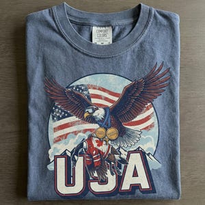 Funny USA Ice Hockey Eagle, USA Champions 2026 Shirt, USA Hockey Shirt 2026, Patriotic Ice Hockey Tee, Funny Sports Unisex T-shirt Midnight