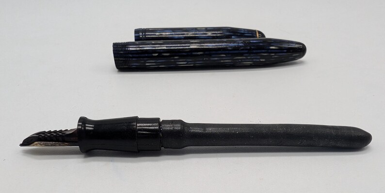 May include: Two blue and white striped fountain pens and a black fountain pen nib.