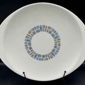 May include: White oval serving platter with a blue, brown, and green geometric pattern around the center.