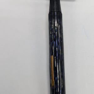 May include: A blue and silver striped fountain pen with a gold trim and a black cap.