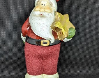 Santa Claus holding a Christmas Star Figurine