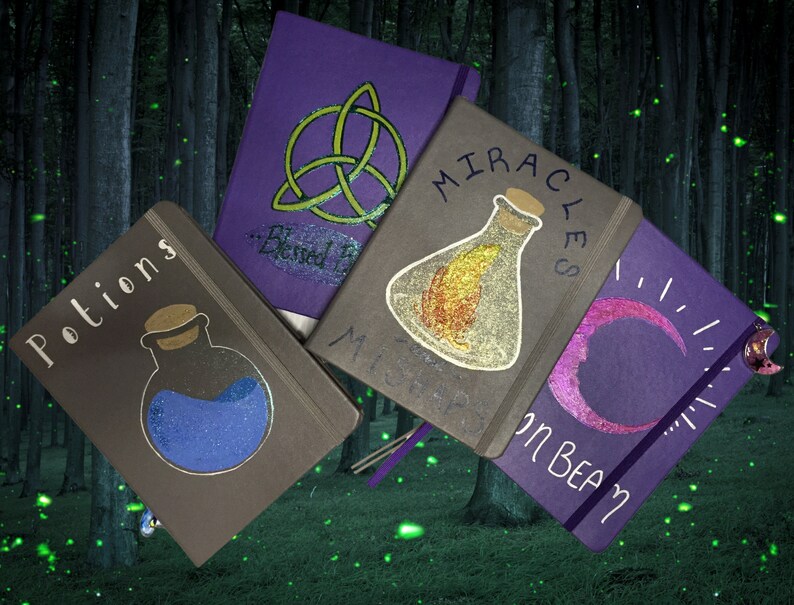 May include: Five purple and gray journals with different designs. The journals have titles that include "Potions", "Miracles", "Blessed", "Mists", and "Moon Beam". Each journal has a different design, including a potion bottle, a crescent moon, a triquetra, and a bottle with a feather inside.