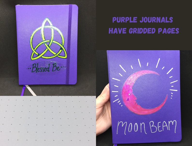 May include: Two purple journals with different designs. The first journal has a green and yellow triquetra symbol with the text "...Blessed Be..." The second journal has a pink crescent moon with white rays and the text "Moon Beam". Both journals have gridded pages.