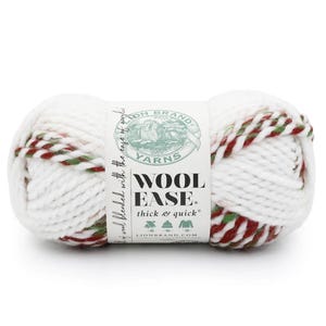 May include: A skein of Lion Brand Wool-Ease Thick & Quick yarn featuring a white base with twisted strands of red and green. A central paper label displays the brand logo, the text Wool Ease, and icons for a scarf, hat, and sweater on a white background.
