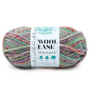 May include: A skein of Lion Brand Wool Ease yarn in the color "Thick & Quick" with a multi-colored pattern of green, pink, orange, and gray. The label reads "Wool Ease Thick & Quick" and "Lion Brand.com".