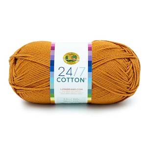 May include: A skein of Lion Brand 24/7 Cotton yarn in the color "Mustard". The yarn is a medium weight and is 100% cotton. The skein is labeled with the Lion Brand logo and the yarn name and weight.