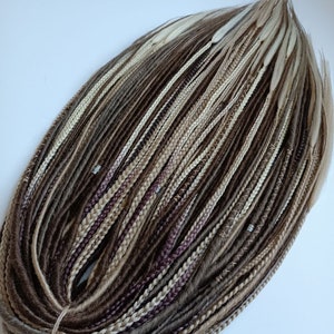 May include: A bundle of brown, blonde, and white synthetic hair extensions. The hair is arranged in a circle and is ready to be used for braiding.