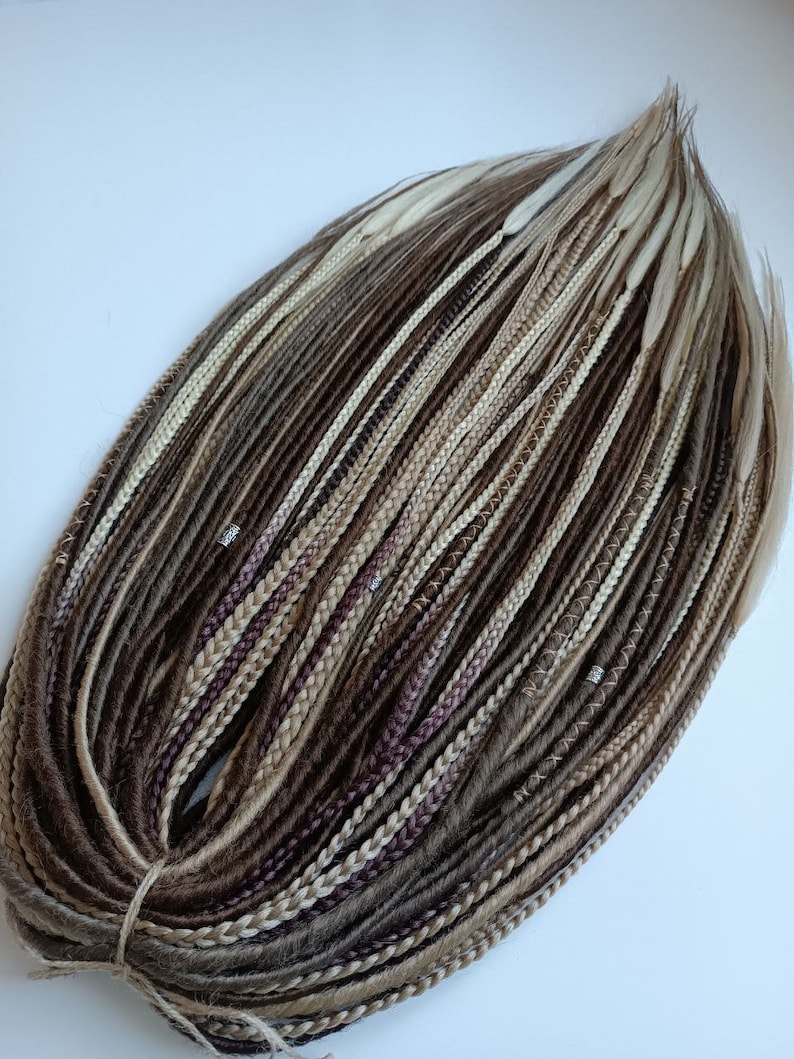 May include: A bundle of brown, blonde, and white synthetic hair extensions. The hair is arranged in a circle and is ready to be used for braiding.