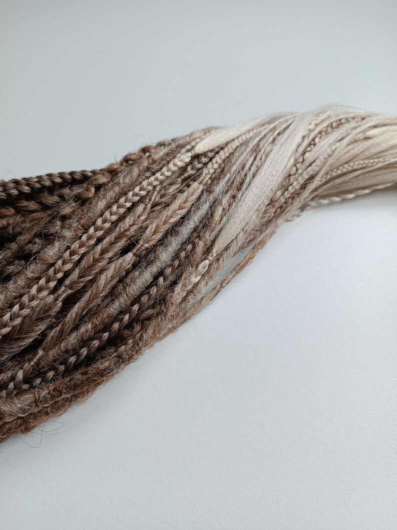 May include: A bundle of brown and blonde synthetic dreadlocks.