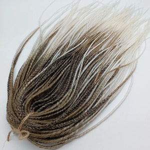 Extensions of thin dreadlocks and boho braids/extensions of dreads light brown, white/dreadlocks, braids DE/dreadlocks in boho style