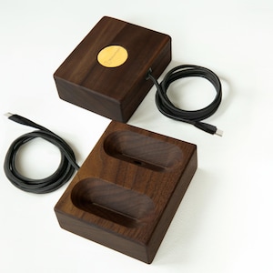 Dark stained walnut wireless magnetic charging stand with AirPods Max, combining elegant craftsmanship with a modern design for a sleek and efficient charging experience