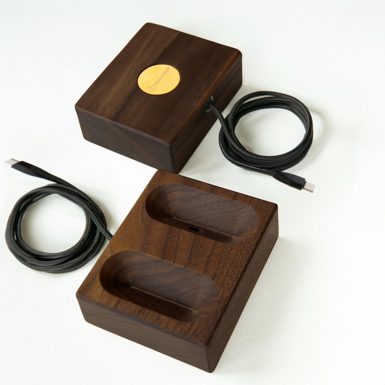 Dark stained walnut wireless magnetic charging stand with AirPods Max, combining elegant craftsmanship with a modern design for a sleek and efficient charging experience