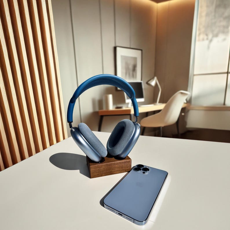 Walnut wireless magnetic charging stand with blue AirPods Max Gen 1 and blue iPhone, demonstrating seamless charging in a modern, stylish setup