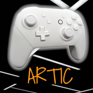 May include: A white wireless video game controller with a white joystick and buttons. The controller has a plus sign button and a home button. The word "ARTIC" is written in orange below the controller.