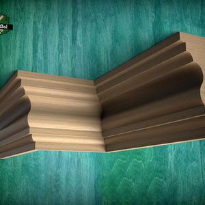 May include: A light brown wooden crown molding piece with a complex curved profile and a sharp corner angle. The piece features a smooth, natural wood grain texture and is positioned against a teal background with a Master Oak logo.