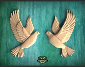 May include: Two wooden dove carvings with outstretched wings, set against a teal background. The birds face each other, showcasing detailed feathering. The logo "Master Oak Since 1996" is at the bottom. A decorative piece for home decor.