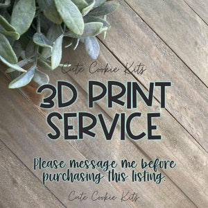 May include: A wooden sign with the text "Cute Cookie Kits 3D PRINT SERVICE Please message me before purchasing this listing. Cute Cookie Kits" in black text on a light brown background.