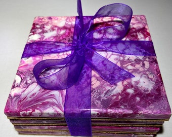 Four ceramic tiles, acrylic paint pour in magenta, pink and white, cork bottom, finished with a coat of resin