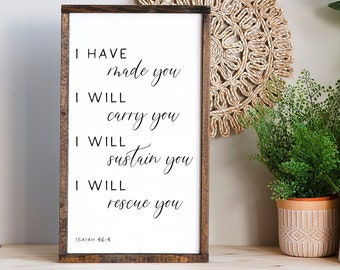 May include: A wooden sign with a white background and black text. The text reads "I HAVE made you I WILL carry you I WILL sustain you I WILL rescue you ISAIAH 46:4".