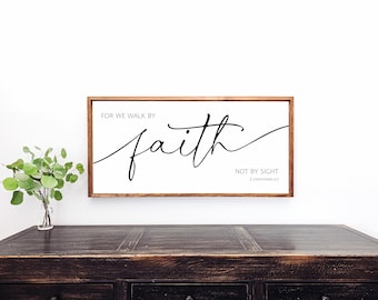 May include: A framed wood sign with the text "For we walk by faith, not by sight. 2 Corinthians 5:7" in black cursive lettering on a white background.