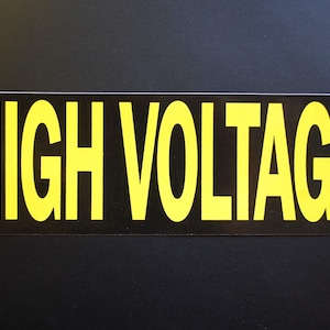 May include: A black and yellow warning sign with the text "HIGH VOLTAGE" in bold yellow letters.