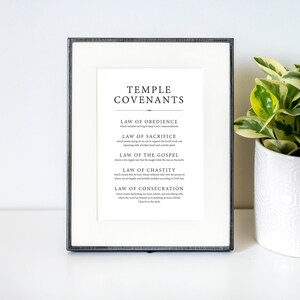 May include: A framed black and white printable with the text "Temple Covenants" and a list of the five temple covenants: Law of Obedience, Law of Sacrifice, Law of the Gospel, Law of Chastity, and Law of Consecration.