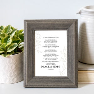 May include: A framed print with a white background and black text. The text reads "The Savior overcame humanity's story BECAUSE OF HIM, we are not here in dread with our failures, sin, and fears, alone. BECAUSE OF HIM, death is not the end. Resurrection will come to all who have your brand. BECAUSE OF HIM, families can be together forever. BECAUSE OF HIM, pain becomes peace, anger becomes love, grief, and despair becomes hope. And gives second chances, new starts, and new beginnings. BECAUSE OF JESUS CHRIST, we celebrate Easter. And Easter is all about PEACE & HOPE."