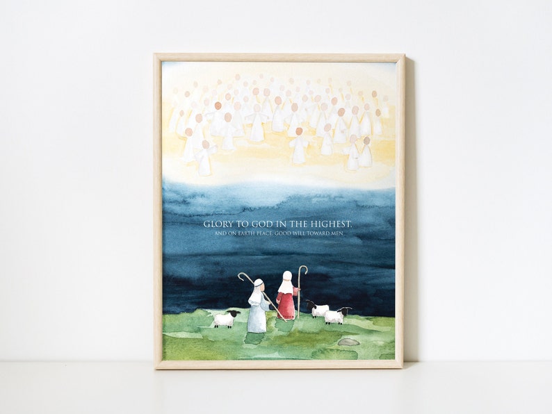 May include: Watercolor print in a light wooden frame. The artwork depicts a celestial scene with angels above, a dark blue sky, and shepherds with sheep below. The text "GLORY TO GOD IN THE HIGHEST. AND ON EARTH PEACE GOOD WILL TOWARD MEN" is included.
