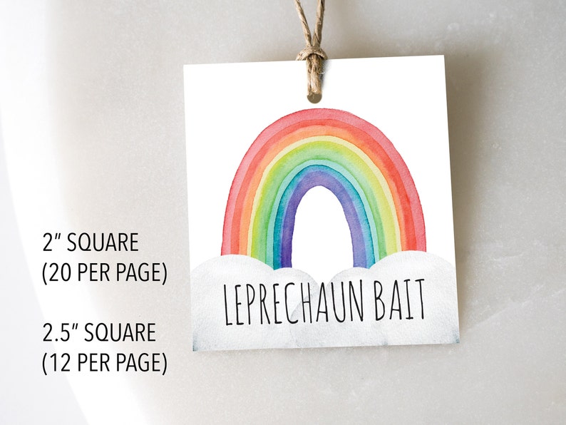 May include: A white square tag with a watercolor rainbow design in red, orange, yellow, green, blue, and purple. The text "LEPRECHAUN BAIT" is below the rainbow. The tag is 2 inches square and has a string for hanging.