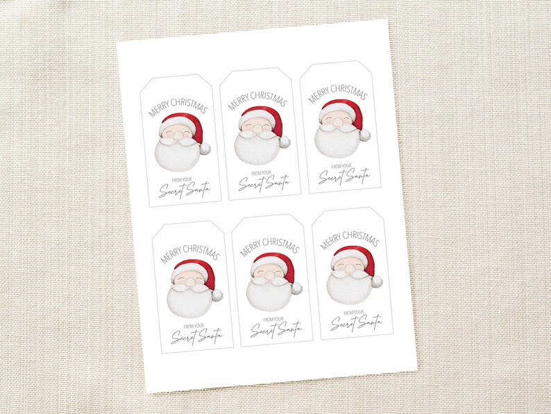 May include: Printable gift tags featuring a cartoon Santa Claus with the text "Merry Christmas" and "From your Secret Santa".