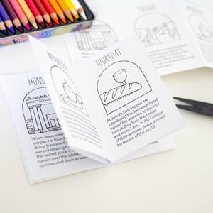 May include: A black and white coloring book with illustrations of scenes from the Bible. The book is folded open to the Thursday page, which depicts Jesus' Last Supper. The text on the page reads "At Jesus's Last Supper, He introduced the Sacrament and invited His apostles to think of Him as they took the bread and wine. Later, in the Garden of Gethsemane, Jesus atoned for the sin of the world."