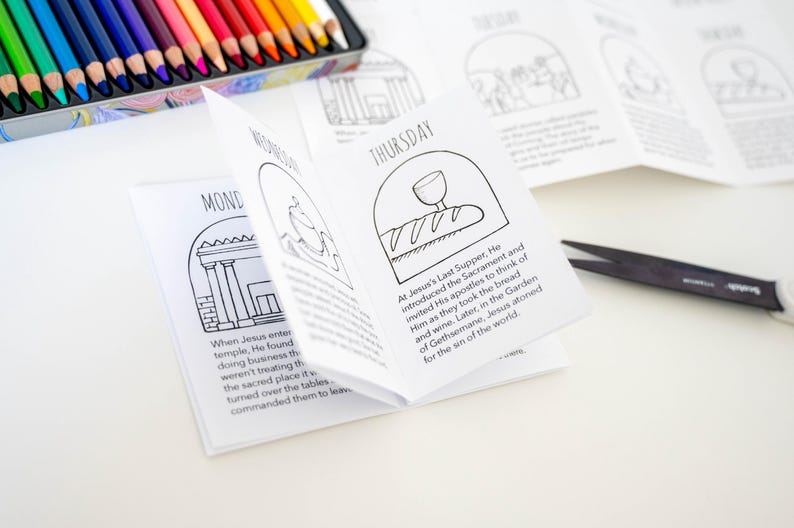 May include: A black and white coloring book with illustrations of scenes from the Bible. The book is folded open to the Thursday page, which depicts Jesus' Last Supper. The text on the page reads "At Jesus's Last Supper, He introduced the Sacrament and invited His apostles to think of Him as they took the bread and wine. Later, in the Garden of Gethsemane, Jesus atoned for the sin of the world."